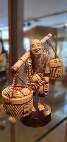 Old peasant with baskets